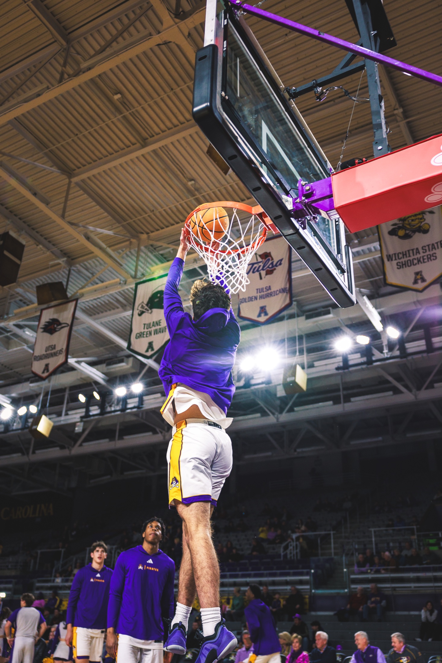 ECU player rising for a dunk during warmups