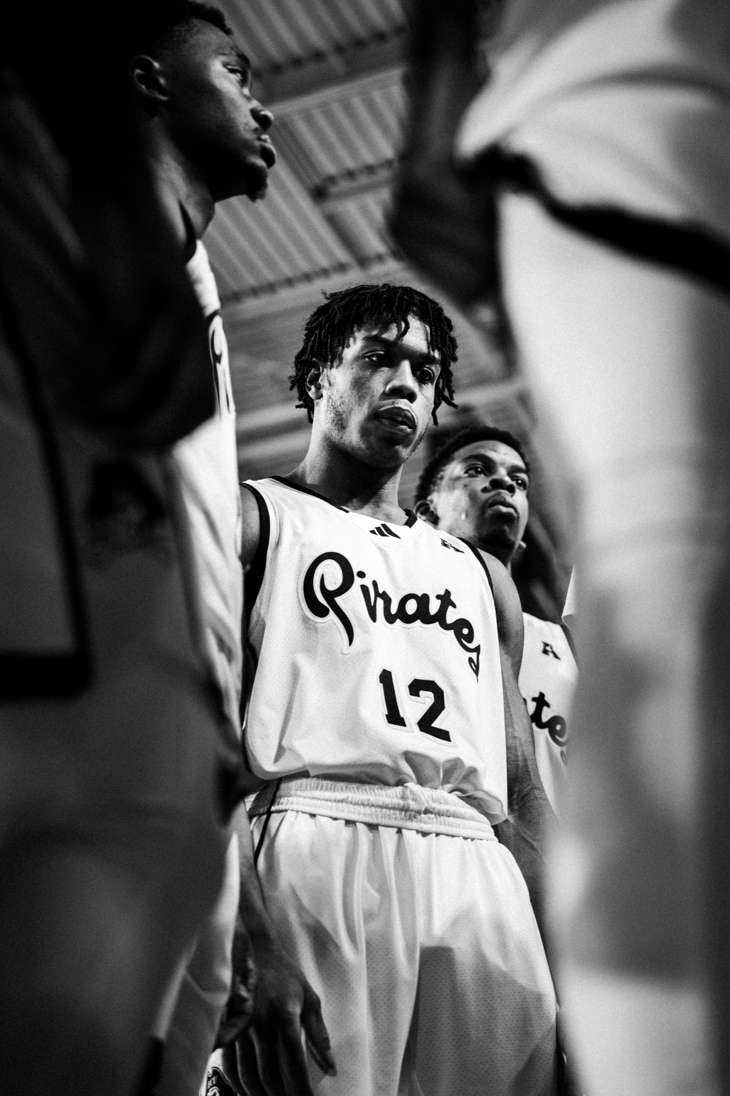 ECU players framed courtside between plays