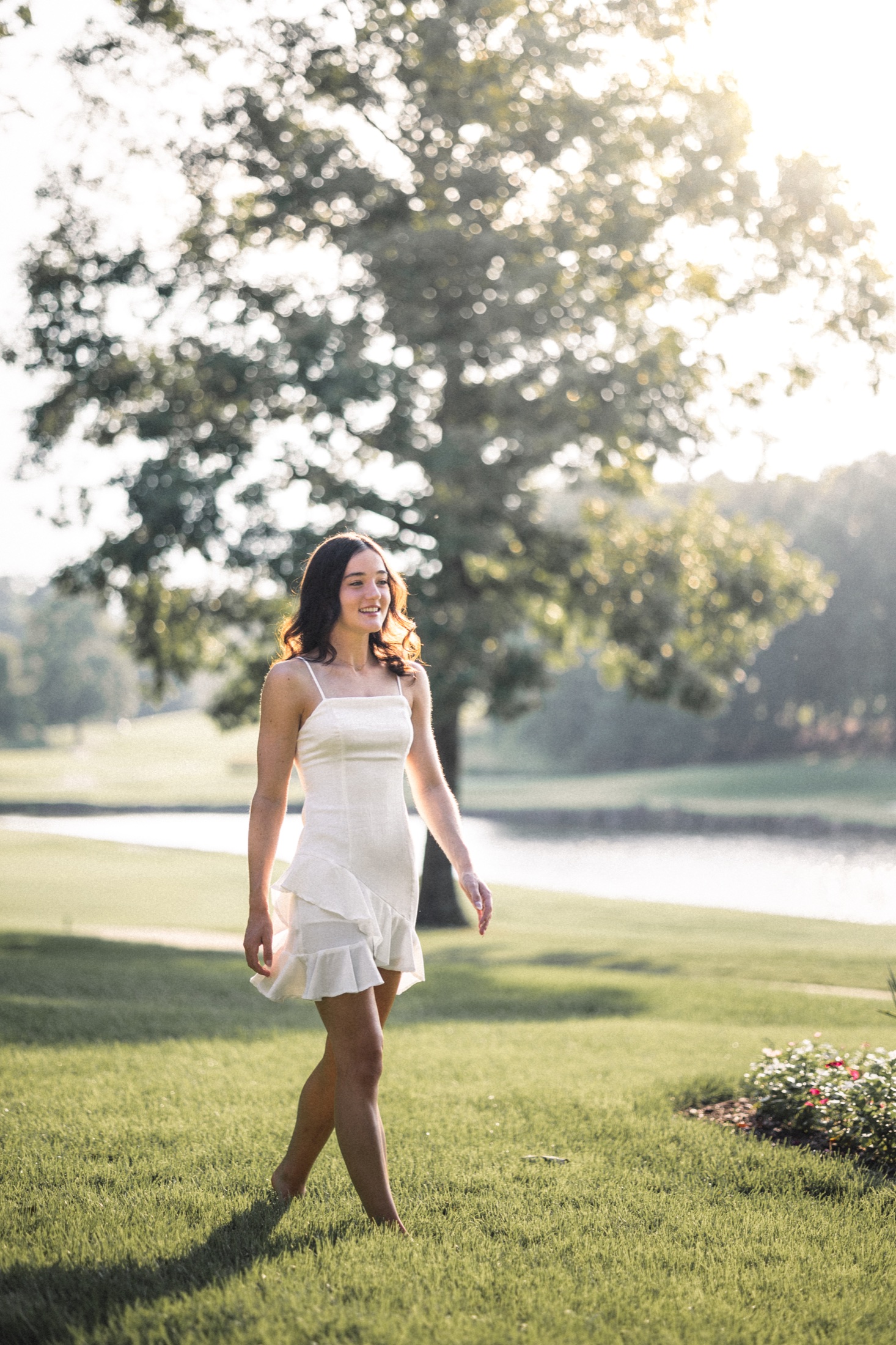 Backlit full-length portrait of Emma Jolliff in a white dress