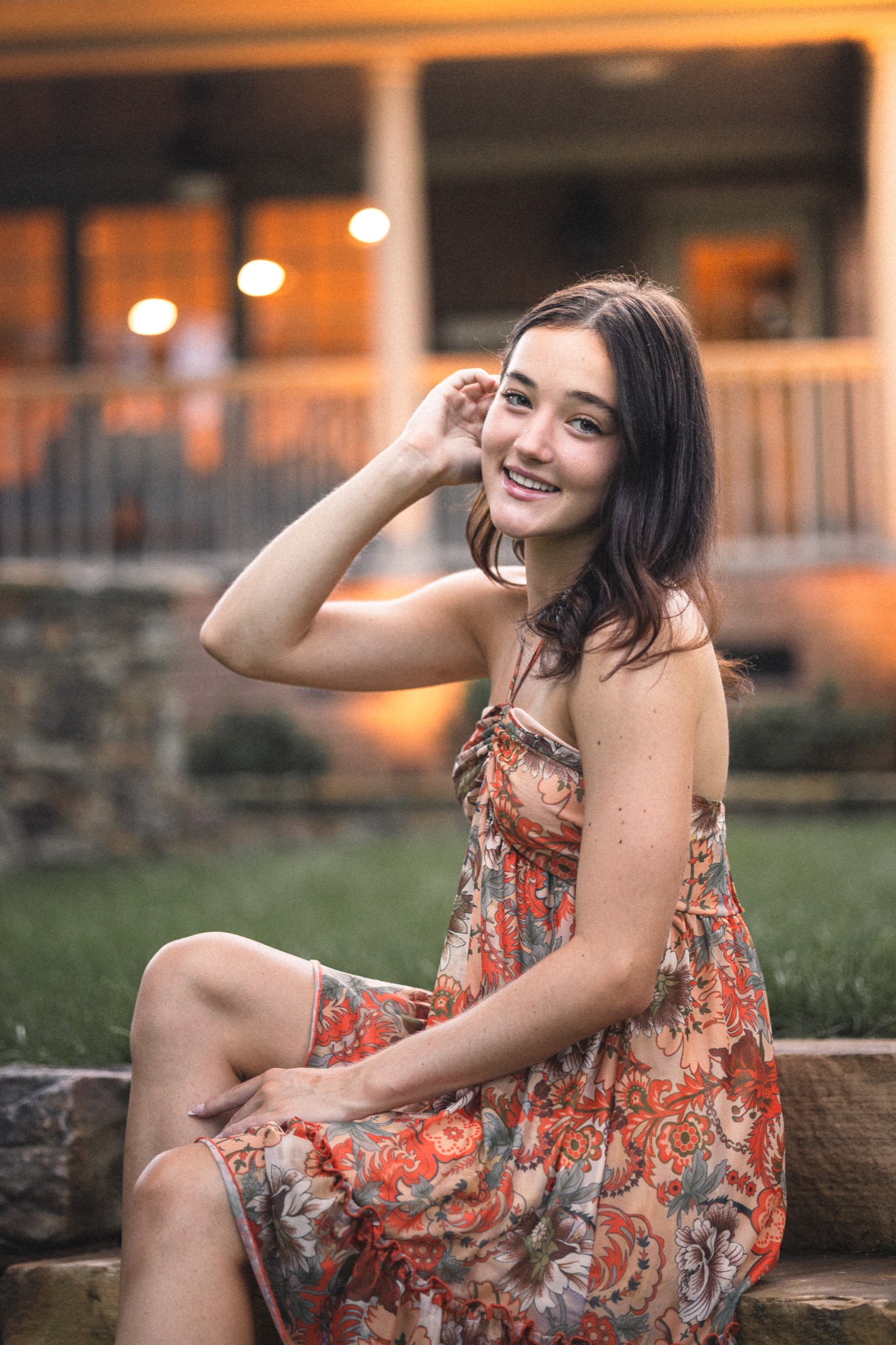 Emma Jolliff photographed outdoors in an orange dress