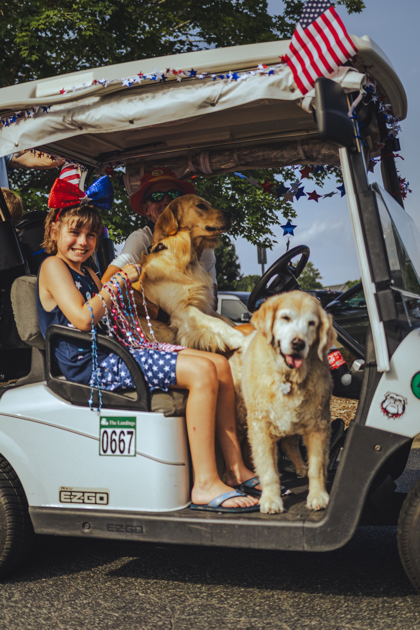 A family and their dogs riding in a decorated golf cart at Northstone