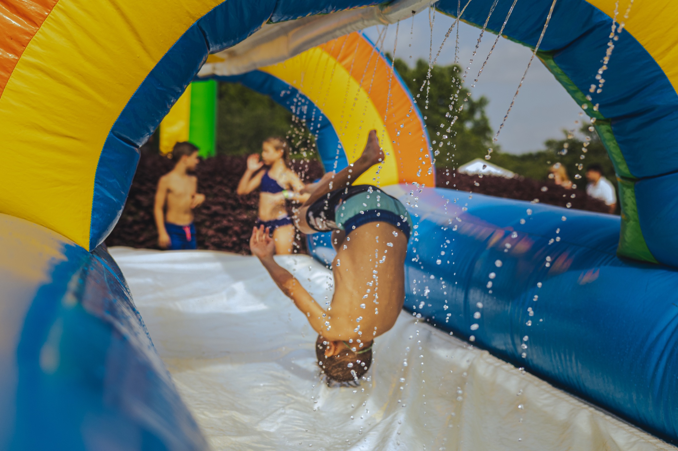Children playing on the water slide at the Northstone block party